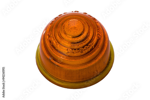Studio photography of an orange headlight isolated on a white background. Close-up shot of a vintage passenger indicator light. Used auto part, classic circular shape.
