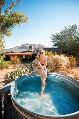 Sweet blonde woman posing in a cowboy bath on vacation. Joshua Tree, California