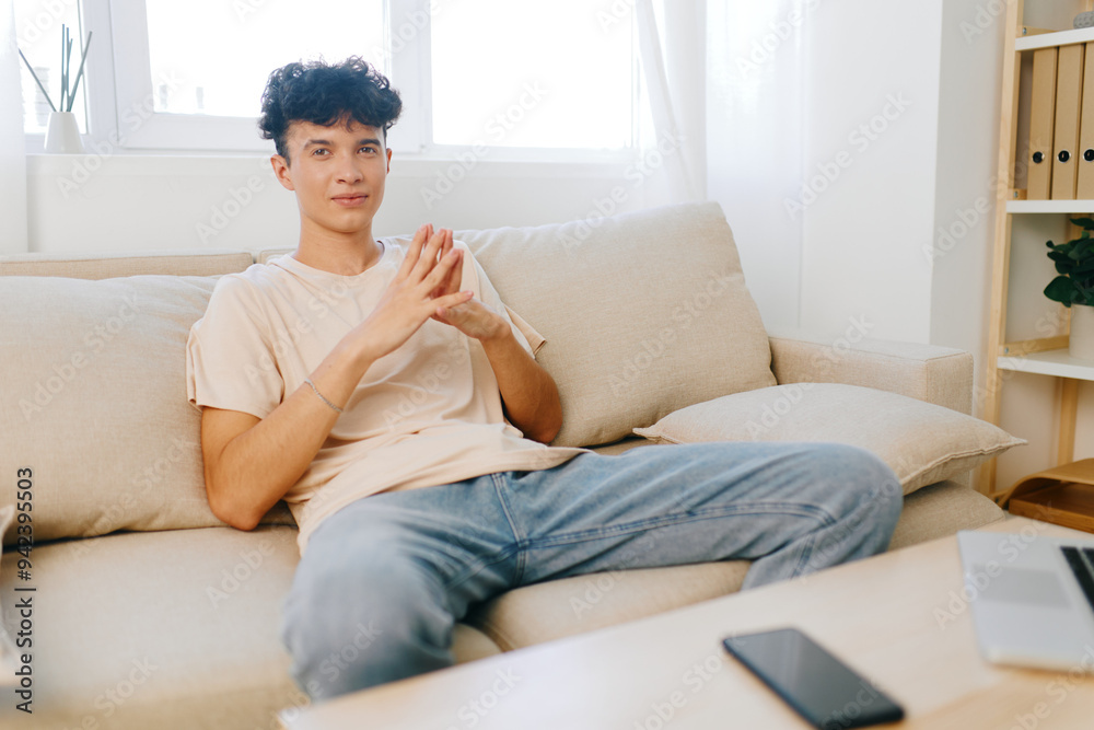 A Casual Young Man Enjoying His Time Relaxing Comfortably at Home While Connected Online A Casual Young Man Enjoying His Time Relaxing Comfortably at Home While Connected Online