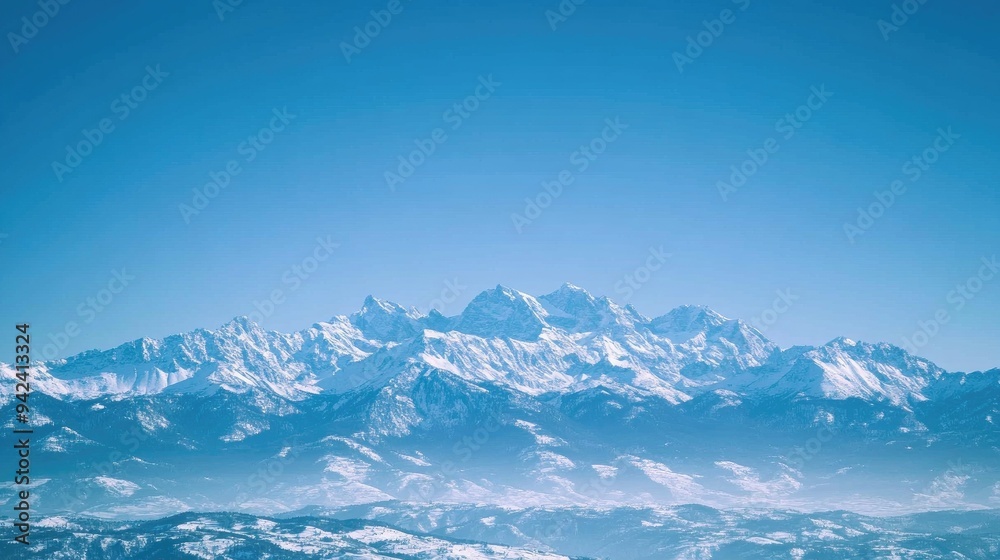 Obraz premium majestic mountain range under a clear blue sky