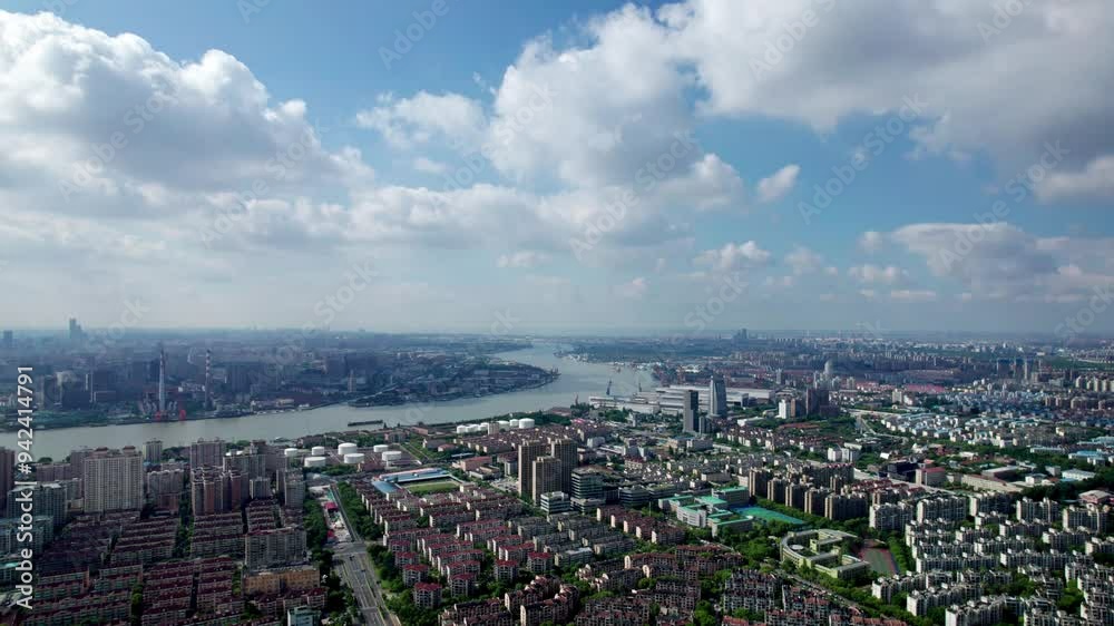 Drone view of Shanghai city in sunny cloudy day, high angle view of ships sailing on Huangpu river and modern buildings with white clouds moving on blue sky, 4k fast motion footage falling effect. Drone view of Shanghai city in sunny cloudy day, high angle view of ships sailing on Huangpu river and modern buildings with white clouds moving on blue sky, 4k fast motion footage falling effect.