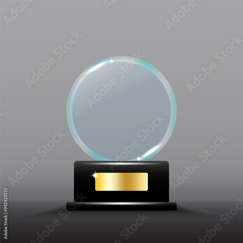 Glass trophy award. Transparent circular shape with shining highlights. Black base with gold plate.