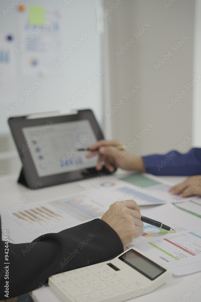 Two businessmen meeting to analyze financial report using laptop on paper on table and analyze dashboard to get business insights. Professional consultant or client with data analysis, graph. Two businessmen meeting to analyze financial report using laptop on paper on table and analyze dashboard to get business insights. Professional consultant or client with data analysis, graph.