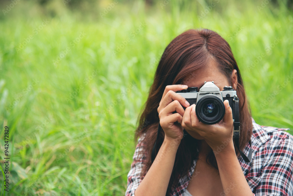 Close up hands Asian Women look at dslr digital camera vintage film style take a photo. Professional female photographer look at picture outdoor. Young woman hands shooting photo in green nature park Close up hands Asian Women look at dslr digital camera vintage film style take a photo. Professional female photographer look at picture outdoor. Young woman hands shooting photo in green nature park