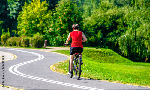 Wallpaper Mural Cyclist ride on the bike path in the city Park
 Torontodigital.ca