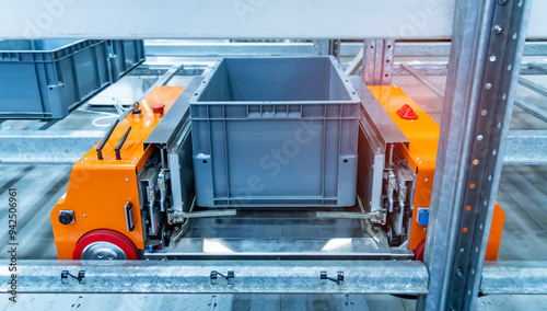 plastic boxes in the cells of the automated warehouse. Metal construction warehouse shelving