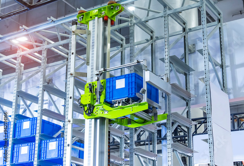 plastic boxes in the cells of the automated warehouse. Metal construction warehouse shelving photo