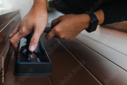person entering passcode on smart door lock system