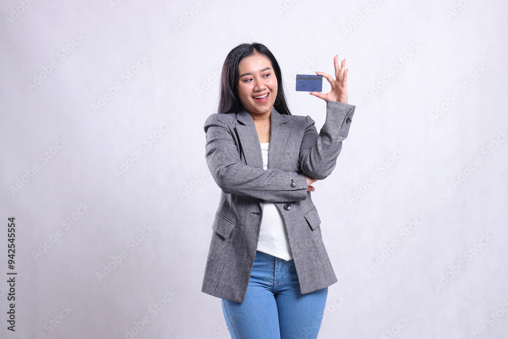 beauty young office girl asia happy embrace look and hold debit credit card wearing grey suit standing isolated on white background. for advertising content, lifestyle, finance, transaction