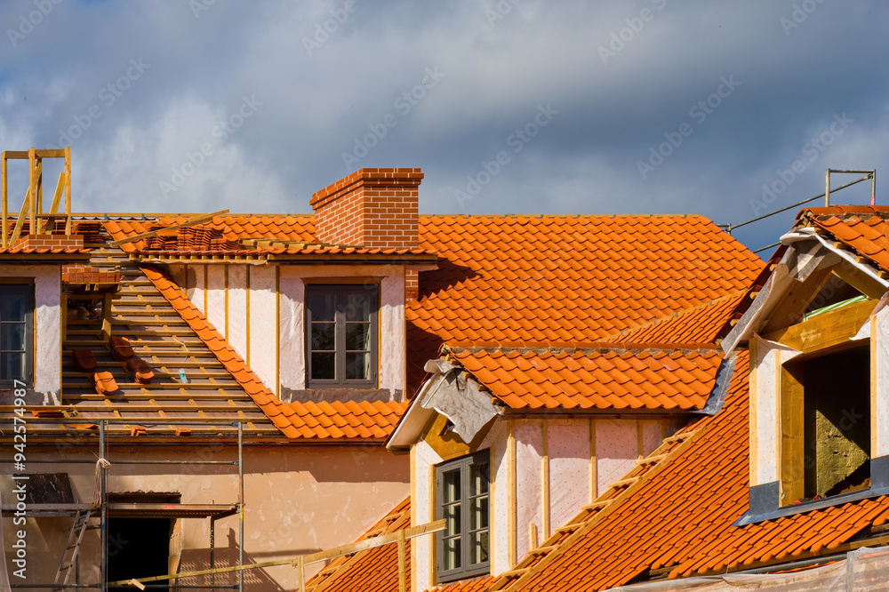 Tile roof restoration. Replacing the clay tile roofing of a historic house. Tile roof restoration. Replacing the clay tile roofing of a historic house.
