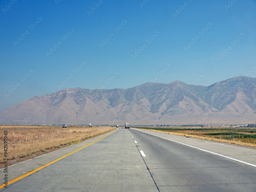 Driving to Oquirrh Mountain range by US route 80 highway on sunny day Driving to Oquirrh Mountain range by US route 80 highway on sunny day