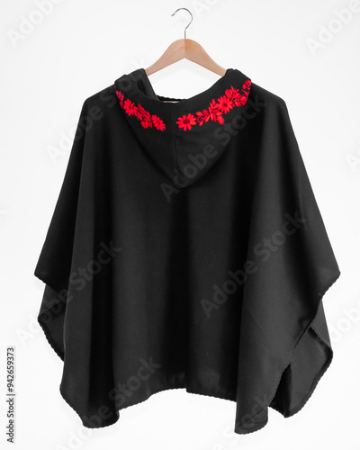 Hand embroidered sheep wool poncho, colorful, flower embroidery, black poncho on white background, no people, Ecuadorian poncho, Andean, handicraft.
