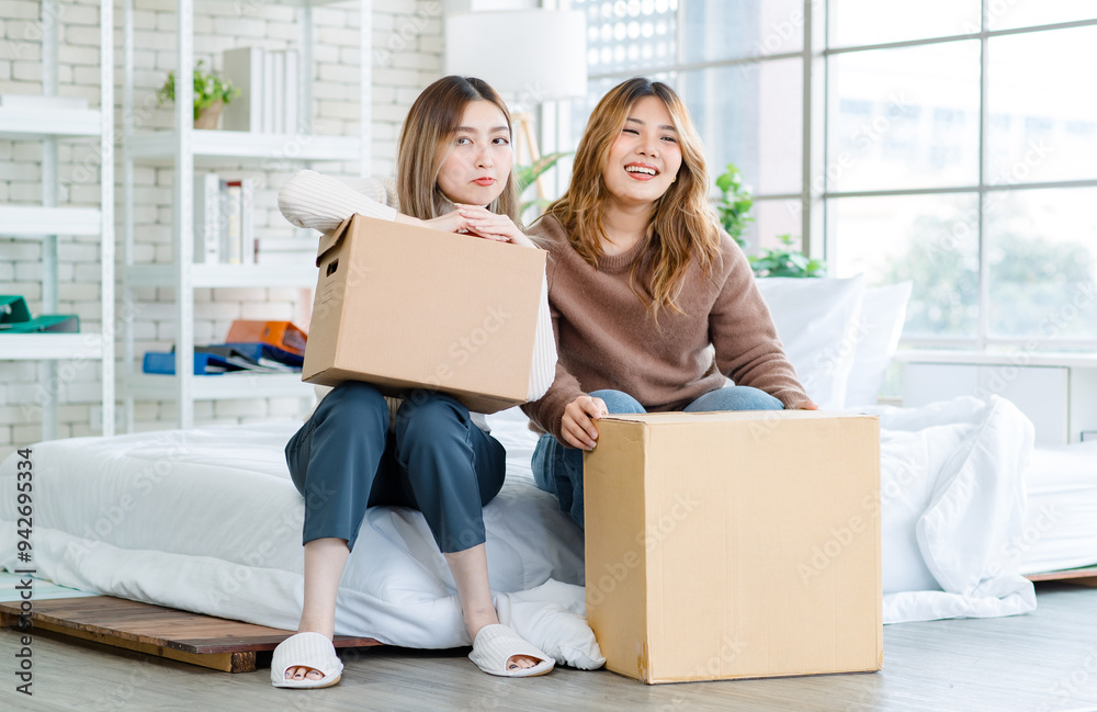 Portrait two roommates happy young Asian female moving packing things in box into new apartment, carry cardboard boxes, Concept teenage or friends, Real estate property buying, relocation, new home Portrait two roommates happy young Asian female moving packing things in box into new apartment, carry cardboard boxes, Concept teenage or friends, Real estate property buying, relocation, new home