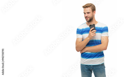 Young man in casual t-shirt holding paper cup of coffee. Drink hot tea isolated on white. Man relaxing with coffee. Takeaway coffee cup. Millennial man enjoying cup of coffee. Copy space banner