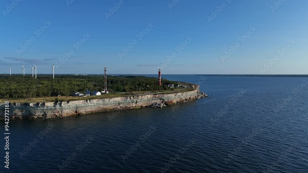 Aerial View of Pakri Cliff with Lighthouse and Sea, Paldiski, Estonia. Aerial view of Pakri Cliff, Paldiski, Estonia, featuring a red lighthouse, calm blue sea, and speedboat passing by. Aerial View of Pakri Cliff with Lighthouse and Sea, Paldiski, Estonia. Aerial view of Pakri Cliff, Paldiski, Estonia, featuring a red lighthouse, calm blue sea, and speedboat passing by.