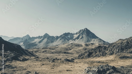 A wide perspective of a rugged mountain range with a clear sky, leaving ample space for text. Ideal for adventure, travel, or outdoor activities.
