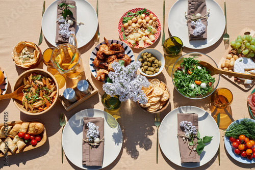 Canvas Print An overhead view of a beautifully arranged summer brunch table featuring various