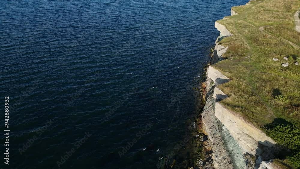 Top-down aerial view of Pakri Cliff in Paldiski, Estonia near Tallinn, captured during a sunny evening showcasing dramatic coastal formations. Top-down aerial view of Pakri Cliff in Paldiski, Estonia near Tallinn, captured during a sunny evening showcasing dramatic coastal formations.