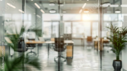 Blurred background featuring a glass-walled office adorned with contemporary furniture and greenery.