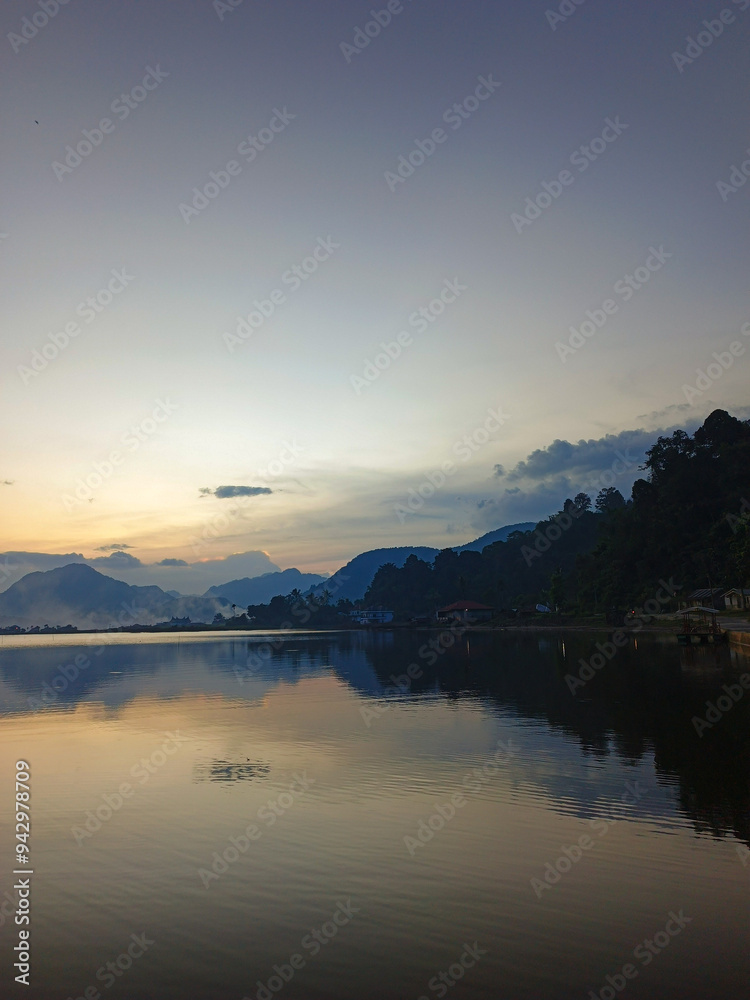 reflection of the evening sunset on a beautiful lake background with a blue orange sky reflection of the evening sunset on a beautiful lake background with a blue orange sky