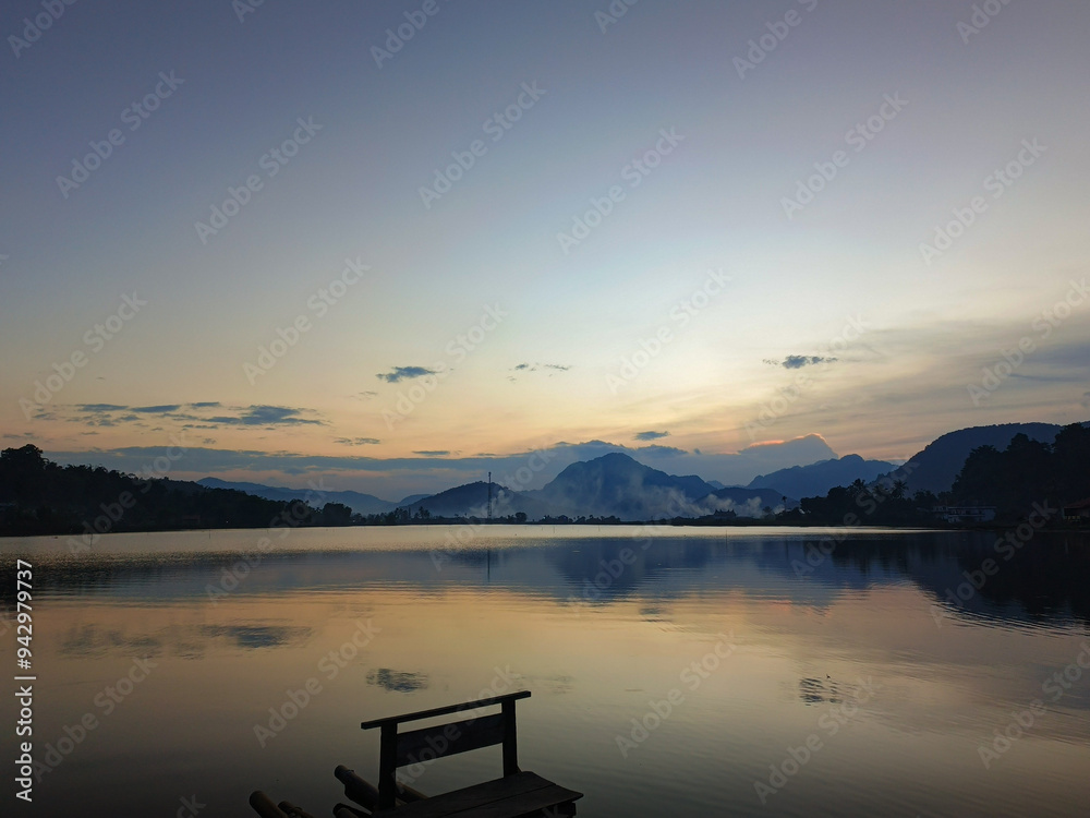 reflection of the evening sunset on a beautiful lake background with a blue orange sky reflection of the evening sunset on a beautiful lake background with a blue orange sky
