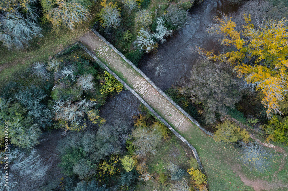Autumnal aerial view of a stone bridge and river Autumnal aerial view of a stone bridge and river