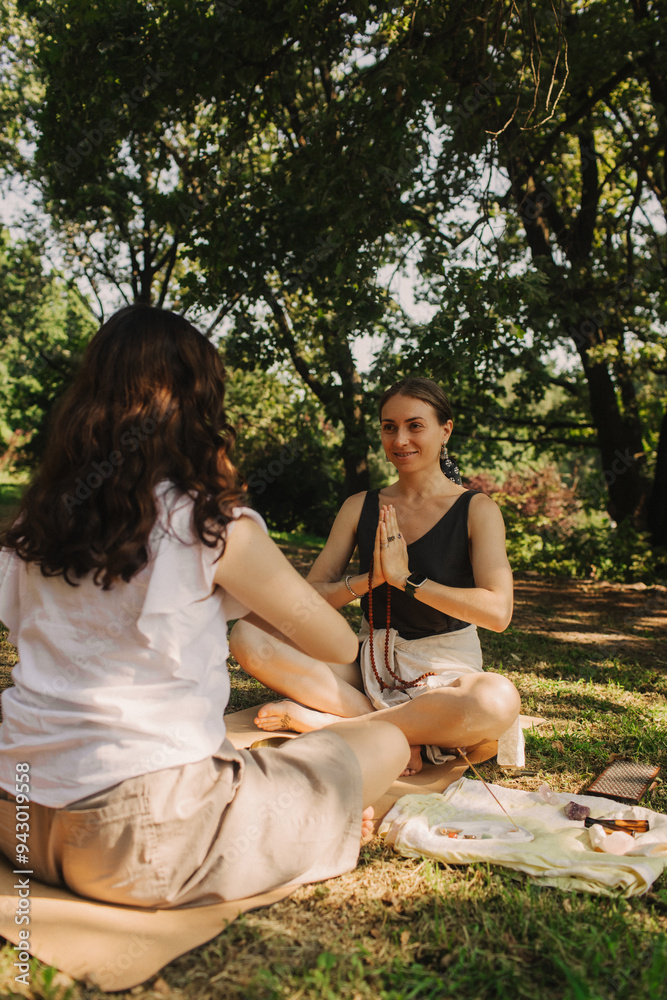 Mentor and student before Mindful meditation and yoga in an open area. Deep relaxation and inner contemplation of people. Facilitating meditative experience. Part of the series. Mentor and student before Mindful meditation and yoga in an open area. Deep relaxation and inner contemplation of people. Facilitating meditative experience. Part of the series.