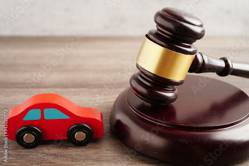 Car accident lawsuit and insurance, Judge hammer with car model.