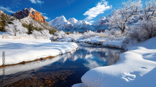 A majestic winter landscape featuring snow-covered mountains, a serene river, and a bright blue sky reflecting tranquility.