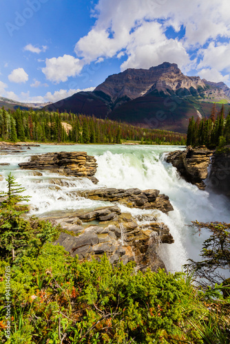 Waterfalls in the rocky mountains. Picturesque Athabasca Falls with Mount Kerkeslin in the background.  Jasper National Park, Alberta, Canada photo