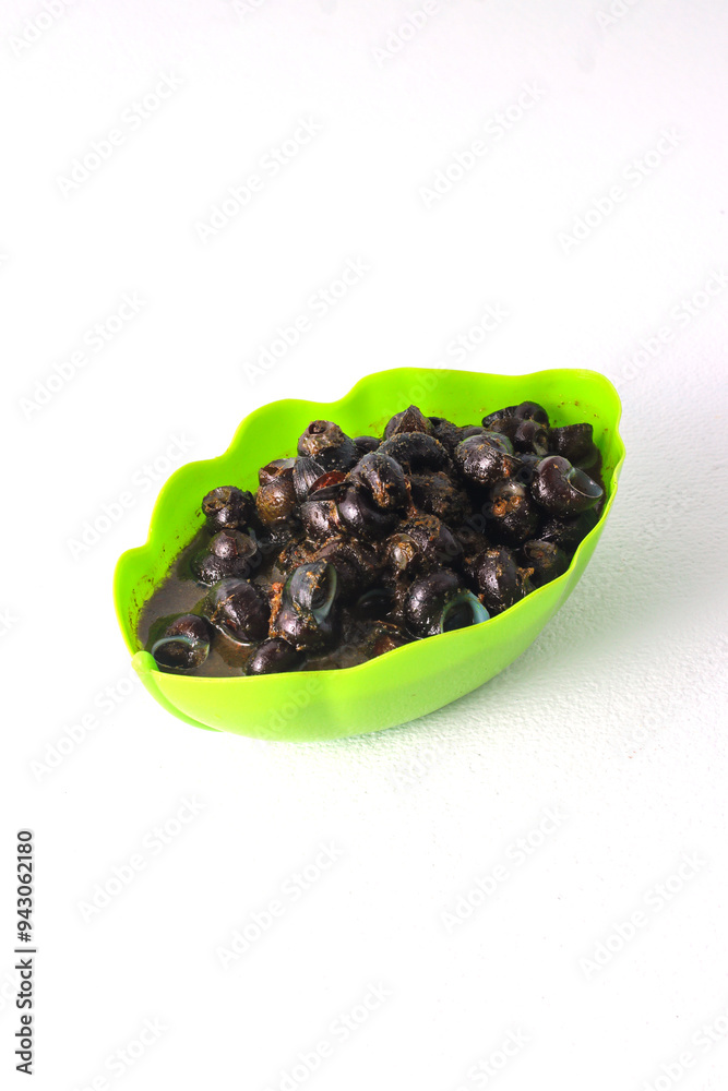 A bowl filled with cooked river snails (tutut) in a spicy sauce. Tutut is a popular dish in some regions of Indonesia, made from freshwater snails. A bowl filled with cooked river snails (tutut) in a spicy sauce. Tutut is a popular dish in some regions of Indonesia, made from freshwater snails.