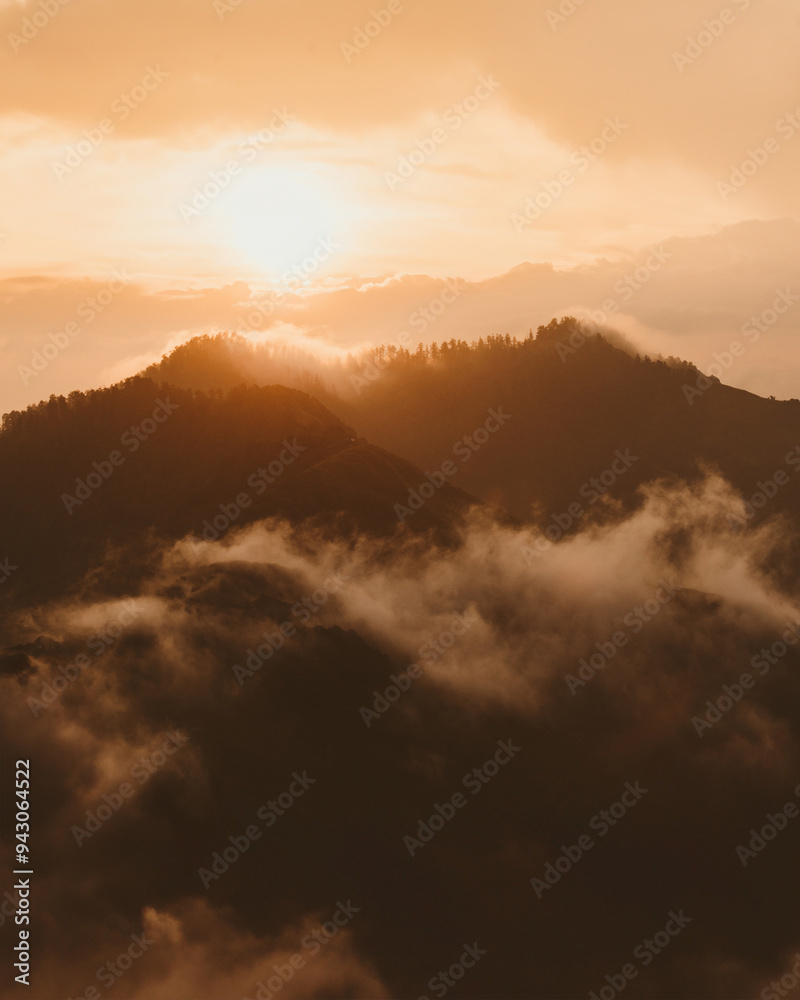Golden hour sunlight piercing through Himalayan cloudy mist Golden hour sunlight piercing through Himalayan cloudy mist