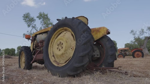 Old abandoned tractor in the countryside, angle view from behind 2
