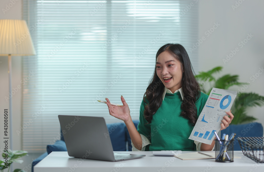 Attractive Asian businesswoman sitting on laptop computer in office Preparing reports, calculating document balance, checking financial documents, making payments happily in the office. Attractive Asian businesswoman sitting on laptop computer in office Preparing reports, calculating document balance, checking financial documents, making payments happily in the office.