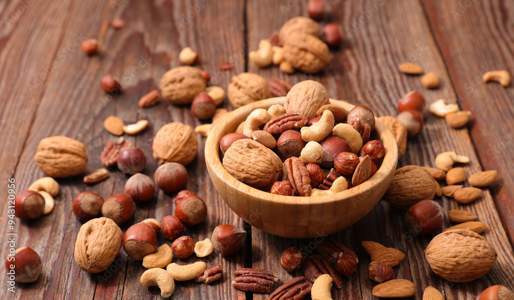 mixed nuts and dried fruits on wood background- healthy snack mixed nuts and dried fruits on wood background- healthy snack