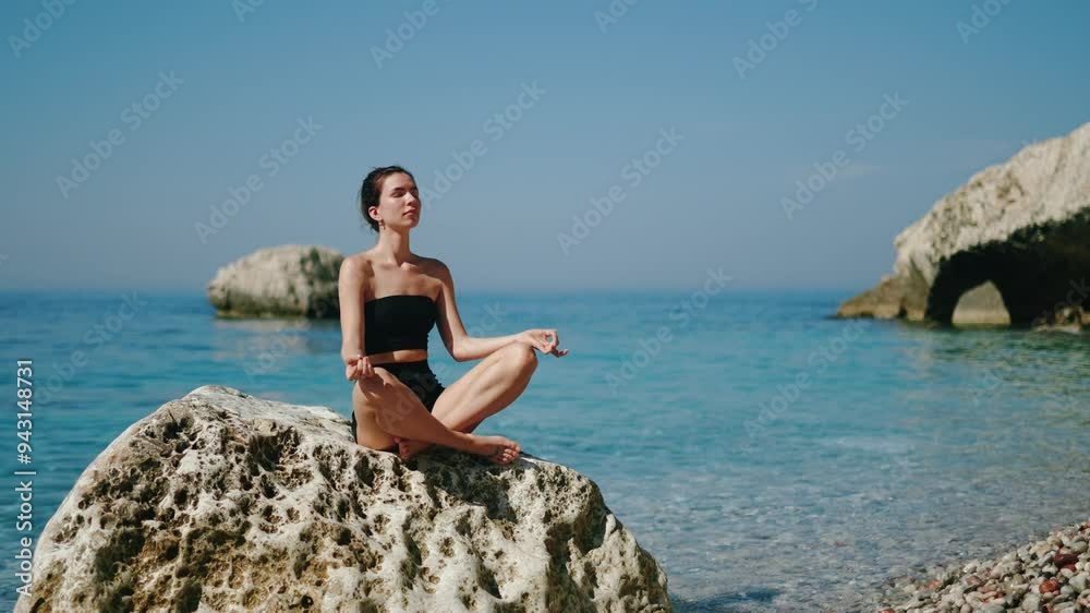 Meditation on a rock right by the beautiful seaside, where the waves softly meet the shore Meditation on a rock right by the beautiful seaside, where the waves softly meet the shore