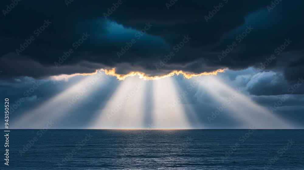 Sun rays breaking through dark storm clouds over the ocean, dramatic weather, hope after the storm Sun rays breaking through dark storm clouds over the ocean, dramatic weather, hope after the storm