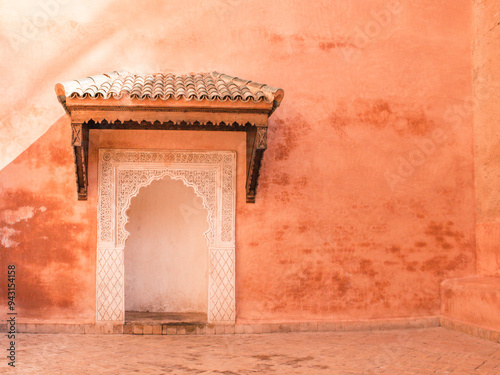 Ancient Moroccan door in terracotta wall, Marrakech, north africa