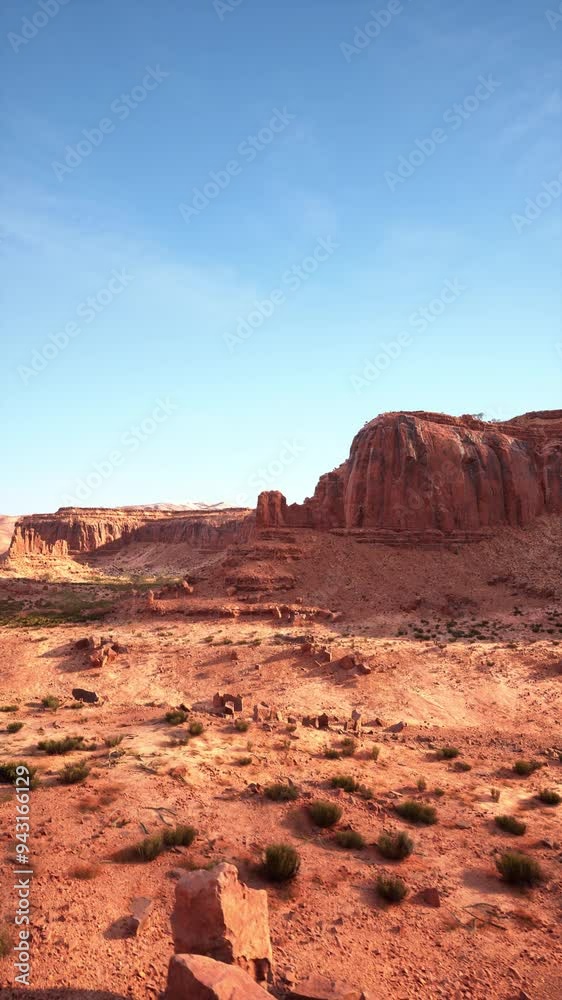 A barren dirt field stretches out with a massive mountain looming in the background in the Nevada desert. A barren dirt field stretches out with a massive mountain looming in the background in the Nevada desert.