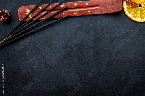 air freshener sticks with cinnamon and orange on dark background top view mockup photo