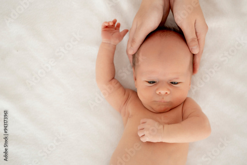 mom's hands hold the baby, a newborn baby with open eyes on a white isolated background, a place for text, a small child, a close-up portrait of the baby