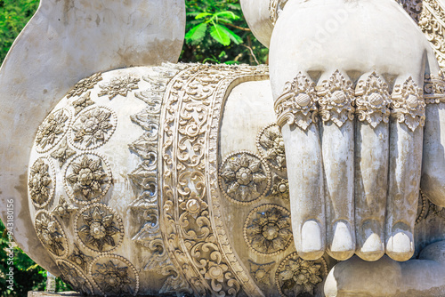 Картината върху платно Background of a religious tourist attraction in Phitsanulok, Thailand, Wat Pa Rang Mi Wanaram, with a large Buddha statue on a mountain, overlooking the surrounding green rice fields