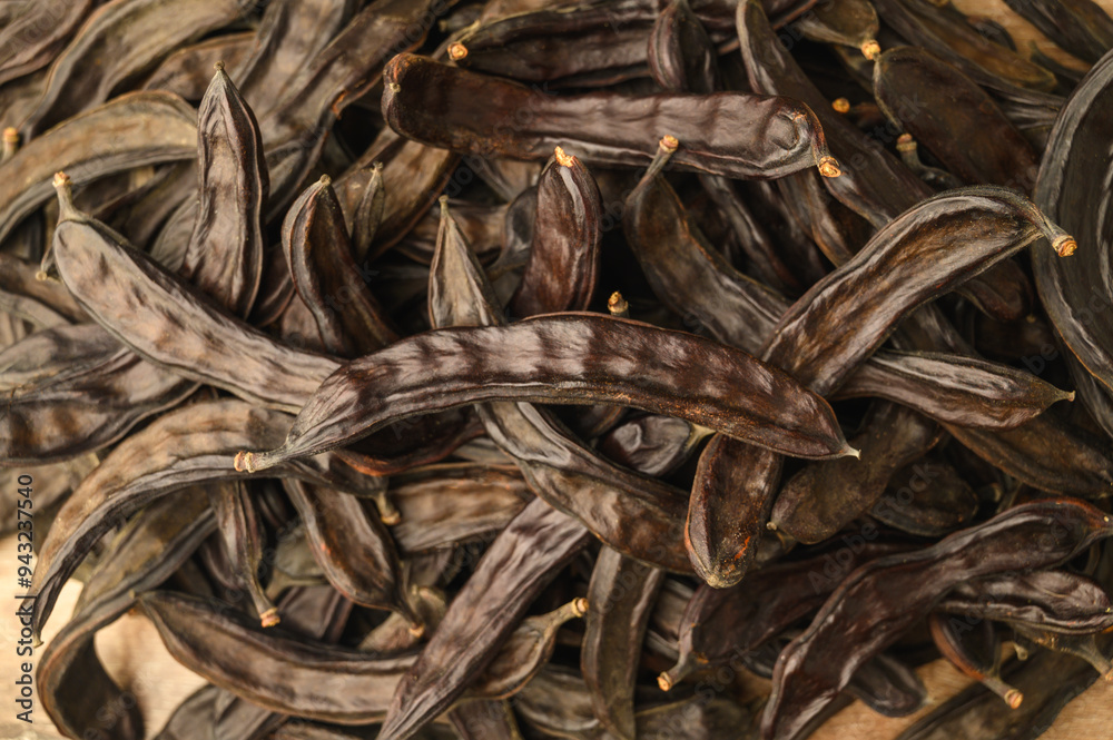 Carob pods and carob on rustic background Carob pods and carob on rustic background