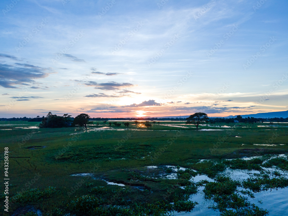 Obraz premium Sunset over the river. Tourism in Bangladesh. Sunset Landscape in Sunamganj, Sylhet, Bangladesh