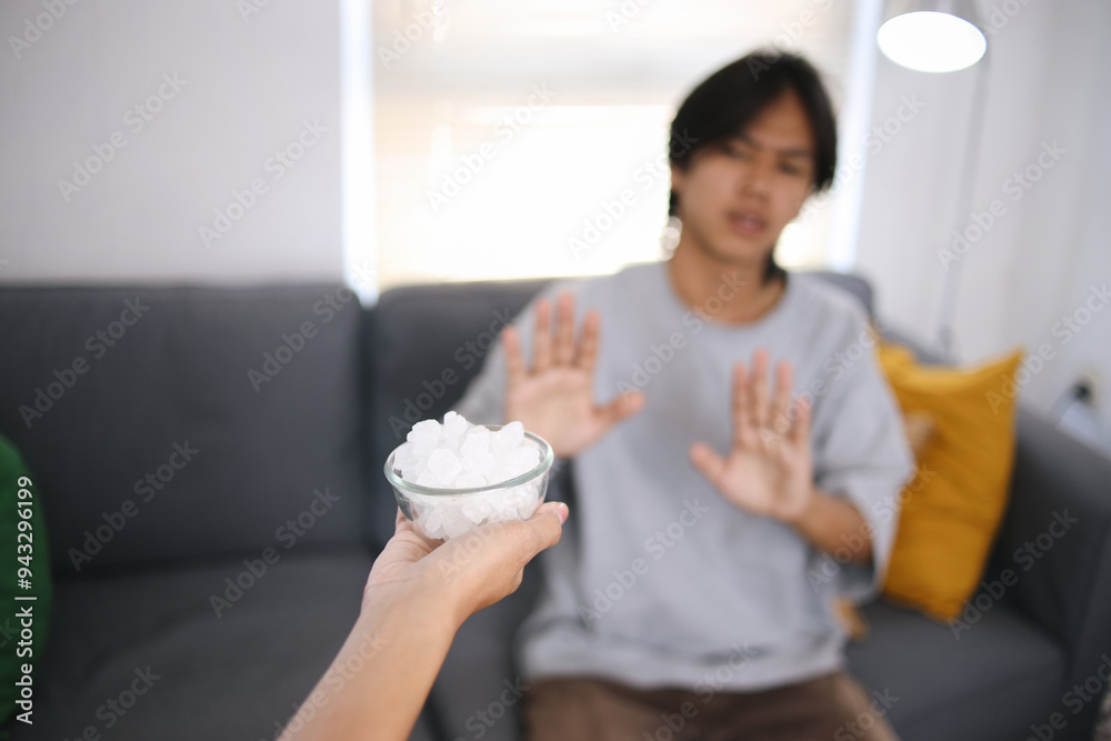 Hand Giving White Sugar Cubes And Man Denial With Blurred Background Hand Giving White Sugar Cubes And Man Denial With Blurred Background