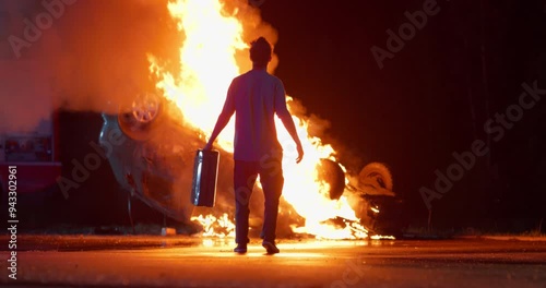 Male Arsonist with a Gasoline Can Ignites a Vehicle, Causing a Massive Fire. Bright Yellow Flames Engulf the Car, Creating a Dramatic and Dangerous Scene at Night. Cinematic Footage