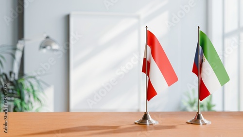 FLAGS OF AUSTRIA AND EQUATORIAL GUINEA ON TABLE