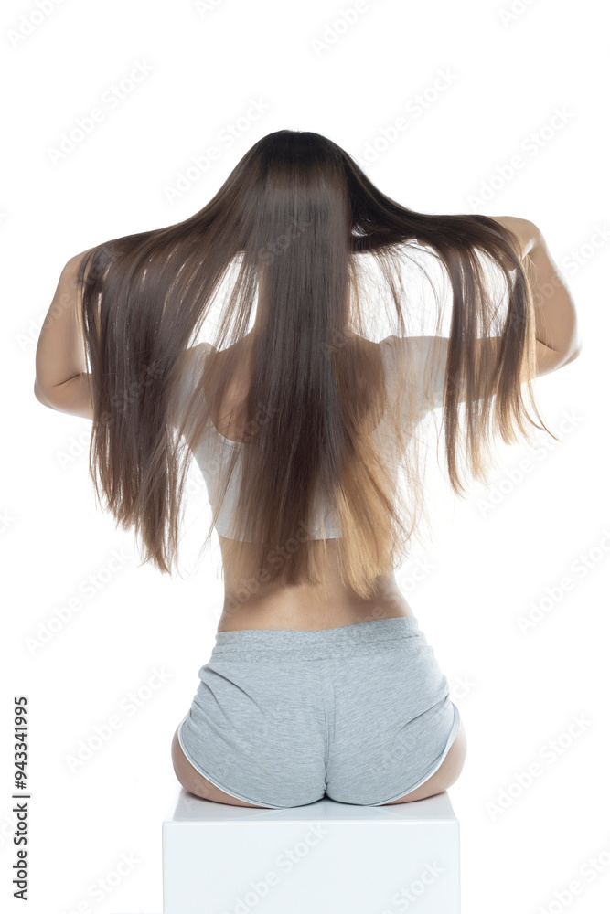 Naklejka premium Woman with long straight hair, rear view, isolated on white background.