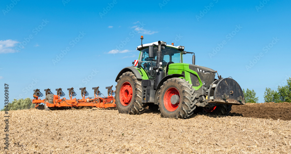 Tractor with 7-share reversible plow cultivating the field after the grain harvest - 2207 Tractor with 7-share reversible plow cultivating the field after the grain harvest - 2207