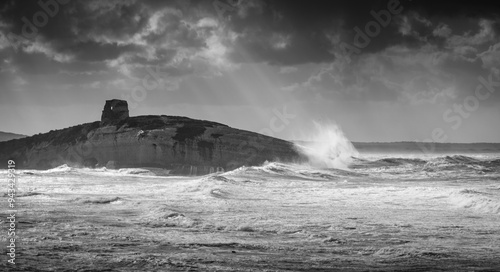 Well tower near S'Archittu in Sardinia with stormy sea photo